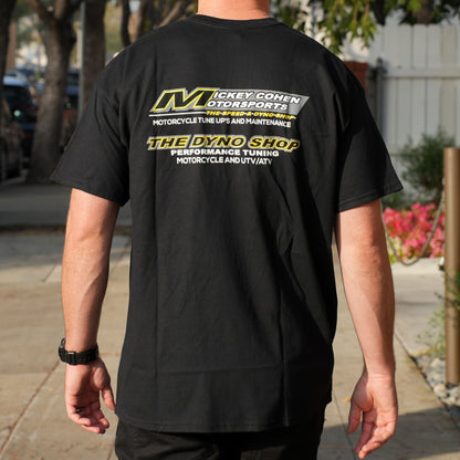 Person wearing a black t-shirt with 'Mickey Cohen Motorports' branding on the back.